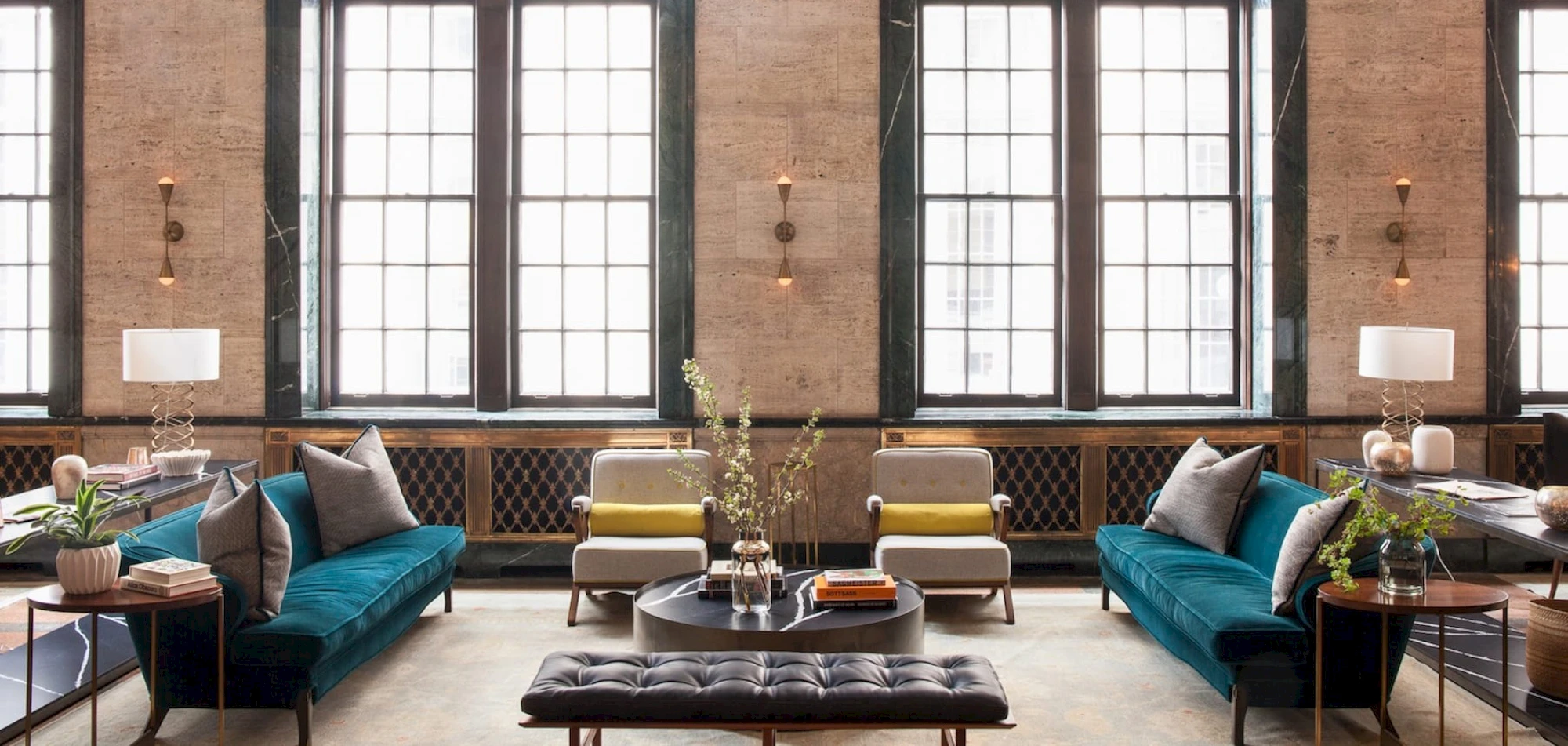 A spacious lobby with a high ceiling, large windows, and comfortable seating areas.