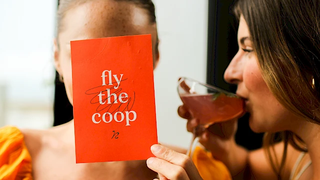 A person holds a red card saying 